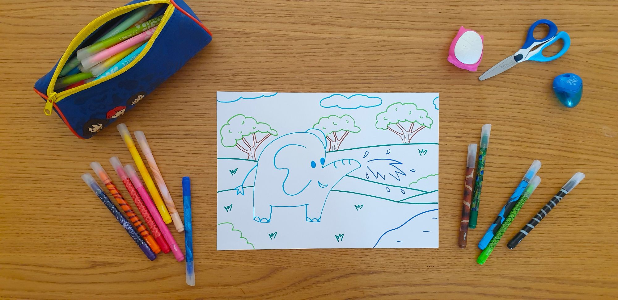 A picture of an elephant on a piece of paper laying on a desk