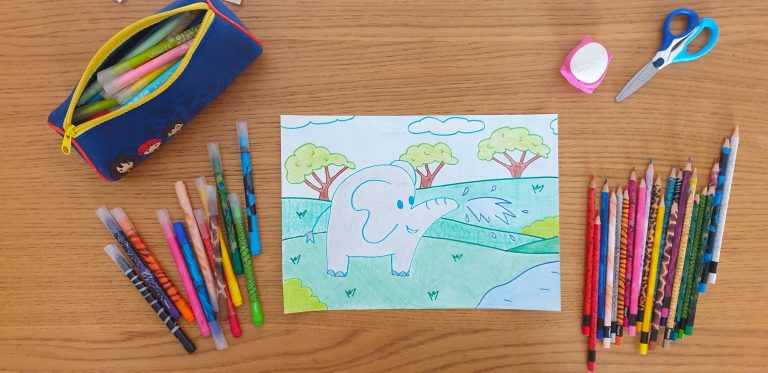 A picture of an elephant on a piece of paper laying on a desk