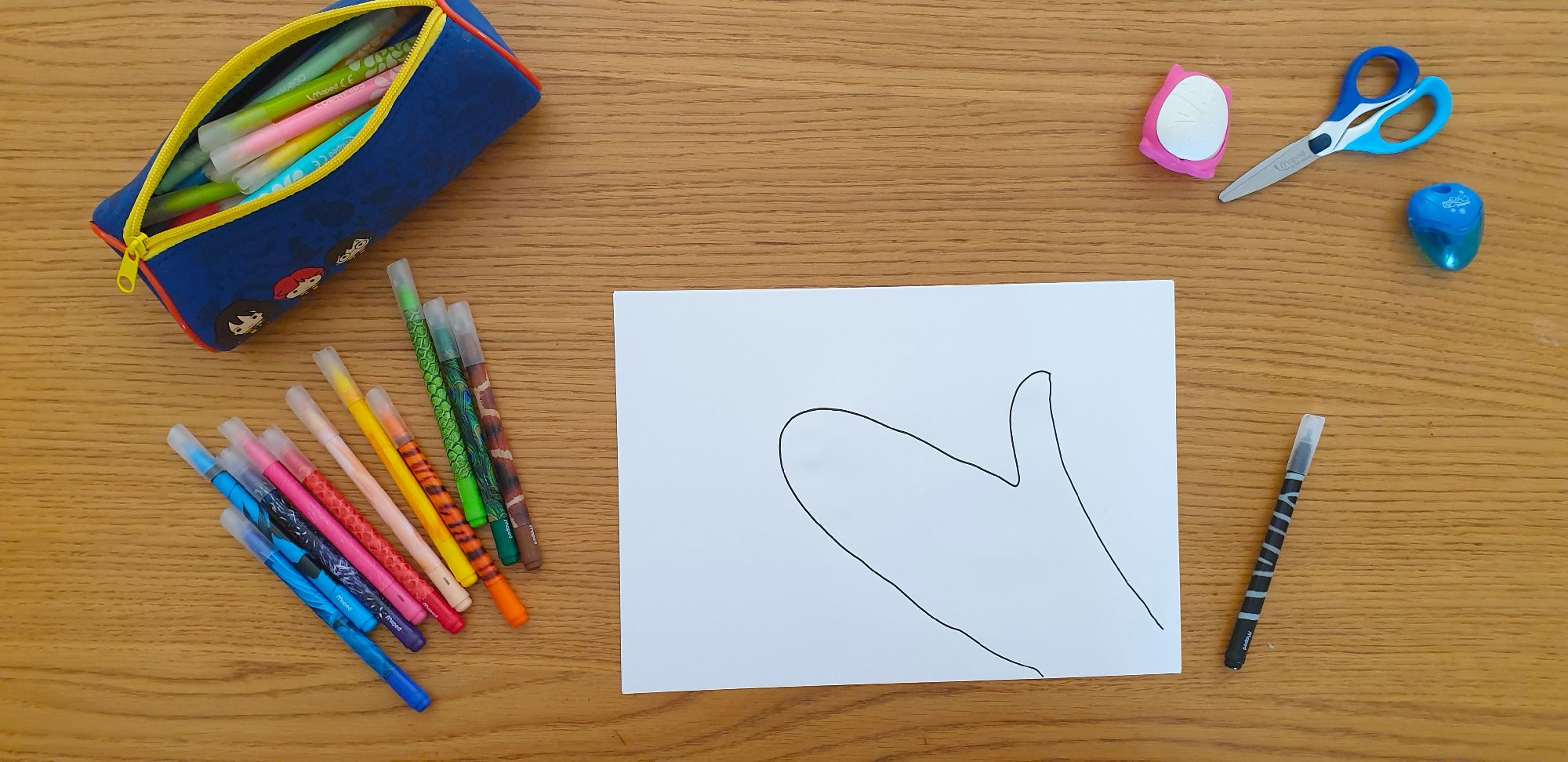 A picture of the outline of a zebra's head on a piece of paper laying on a desk