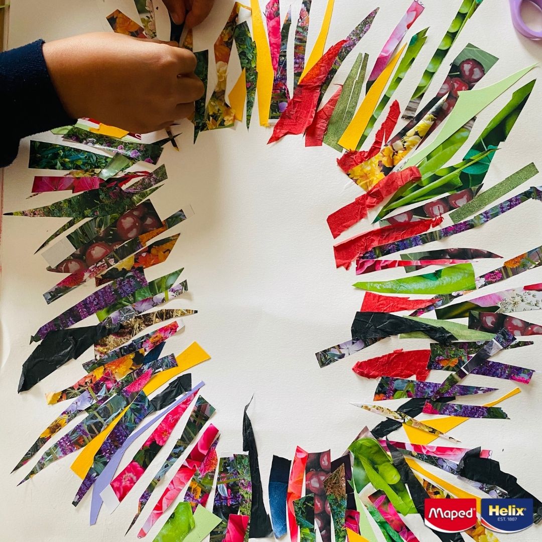 Strips cut from a magazine laying on a piece of paper forming a circle