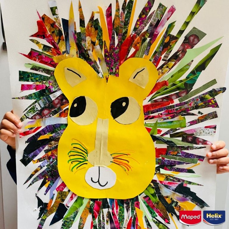 Strips cut from a magazine laying on a piece of paper with a hand drawn image of a lion's face laying on the top
